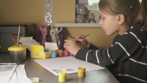 Stock Video Little Girl Painting On A Sheet At Home Animated Wallpaper