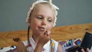 Stock Video Little Girl Painting Her Lips Animated Wallpaper