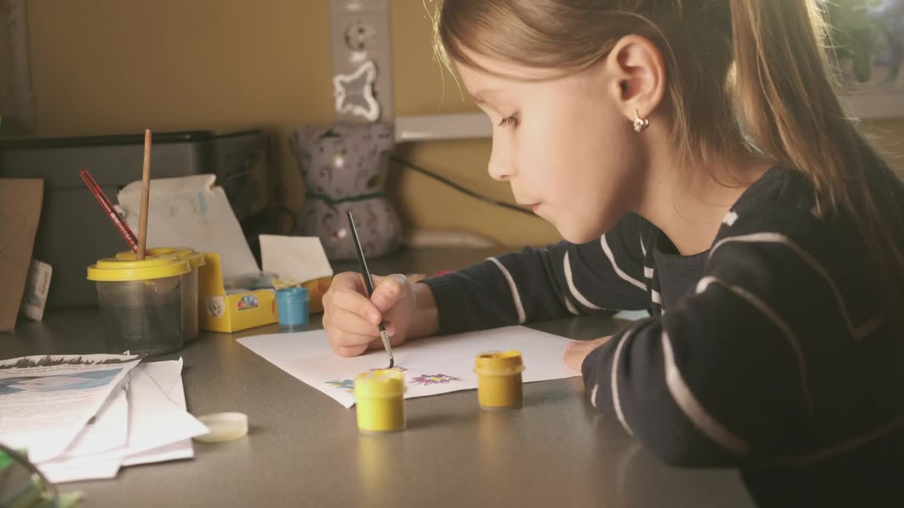 Download Stock Video Little Girl Painting At A Desk Animated Wallpaper