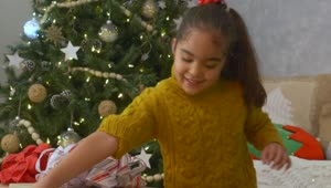 Stock Video Little Girl Opening Her Presents On Christmas Day Animated Wallpaper