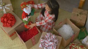 Stock Video Little Girl Opening Gifts At Christmas Animated Wallpaper