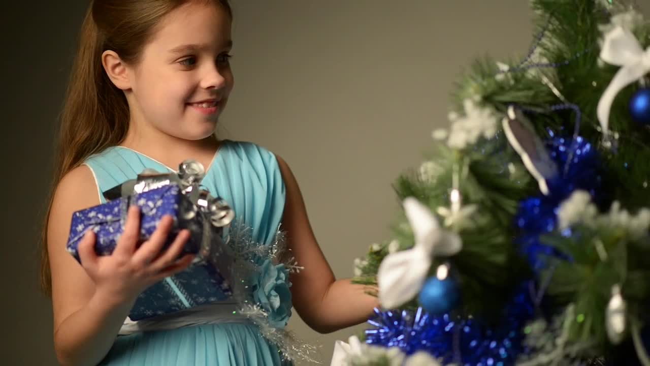 Download Stock Video Little Girl Next To A Christmas Tree Animated Wallpaper