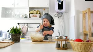 Stock Video Little Girl Making Cookie Mixture In The Kitchen Animated Wallpaper
