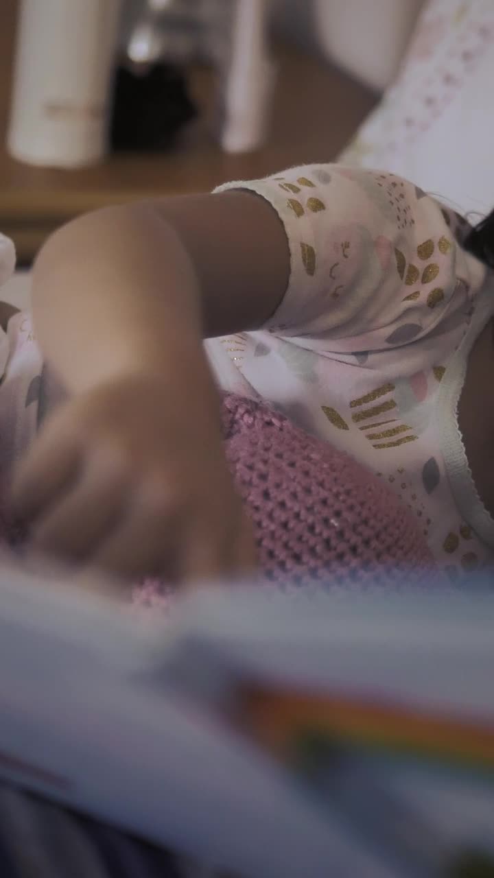 Download Stock Video Little Girl Lying Next To Mom Watching A Storybook With Animated Wallpaper