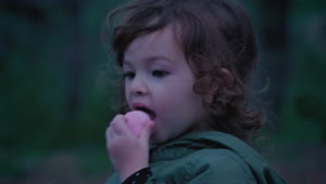 Stock Video Little Girl In Nature Eating A Marshmallow Animated Wallpaper