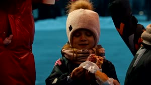 Stock Video Little Girl Eating A Donut On An Ice Rink Animated Wallpaper