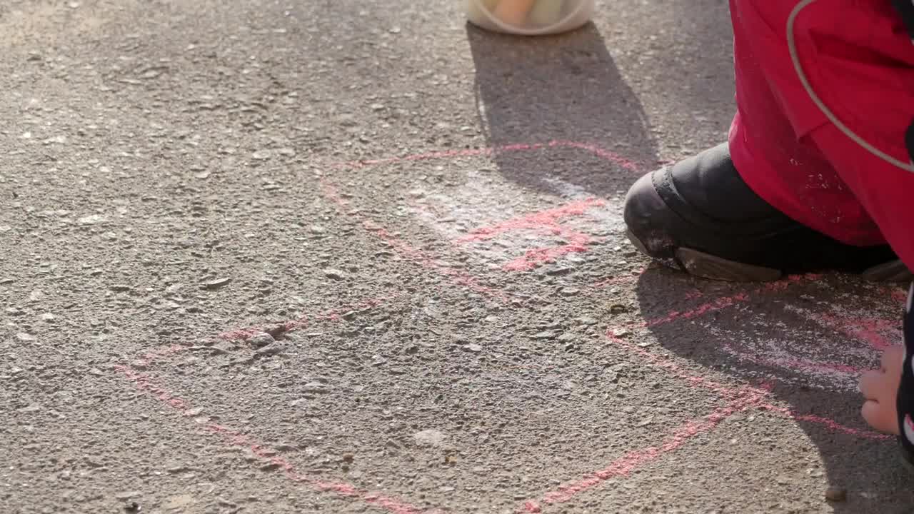 Download Stock Video Little Girl Drawing On The Ground Animated Wallpaper