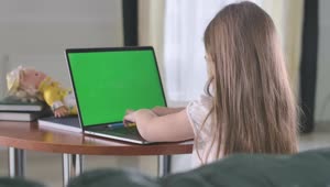 Stock Video Little Girl Doing Homework On A Laptop Animated Wallpaper