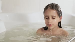 Stock Video Little Girl Dipping Her Hair In The Tub Animated Wallpaper
