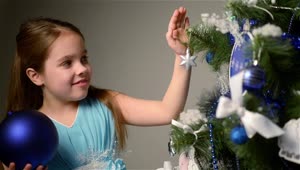 Stock Video Little Girl Decorating Her Christmas Tree Animated Wallpaper