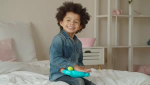 Stock Video Little Boy Happily Playing With A Toy Animated Wallpaper