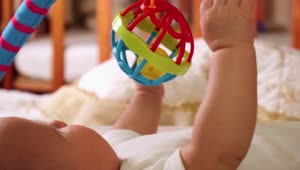 Stock Video Little Baby Playing With Toys On His Bed Animated Wallpaper