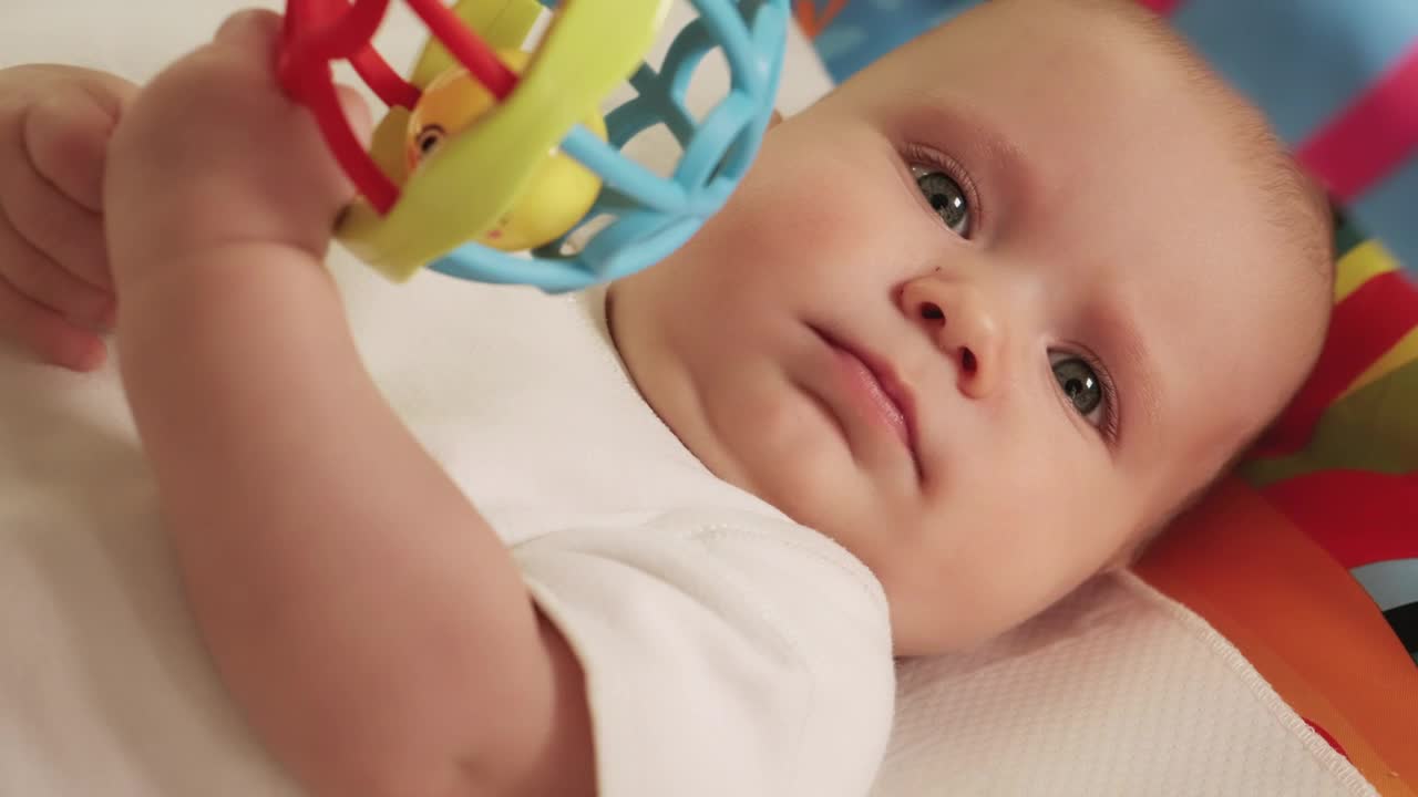 Download Stock Video Little Baby Playing With His Hanging Toy Animated Wallpaper