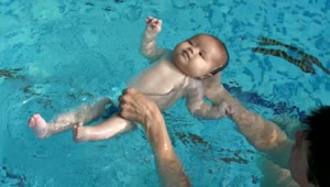 Stock Video Little Baby Learning To Float In The Pool Water Animated Wallpaper