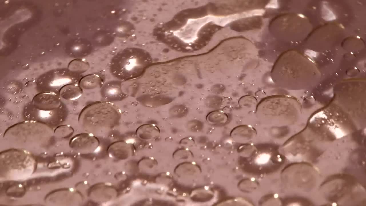 Download Stock Video Liquid On A Plastic Plate Animated Wallpaper