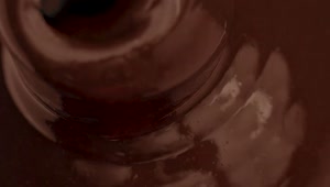 Stock Video Liquid Chocolate Flowing Into A Chocolate Fountain Animated Wallpaper