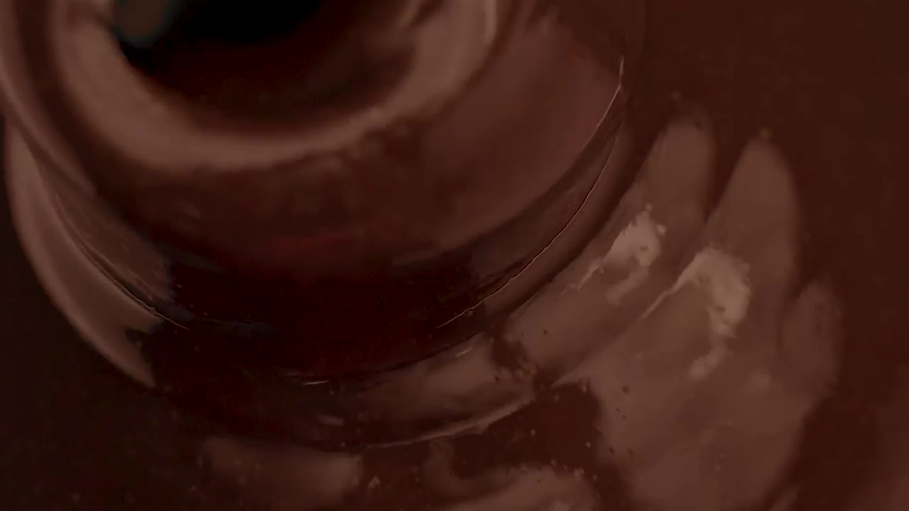 Download Stock Video Liquid Chocolate Flowing Into A Chocolate Fountain Animated Wallpaper