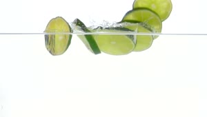 Stock Video Lime Slices Falling Through Water Animated Wallpaper