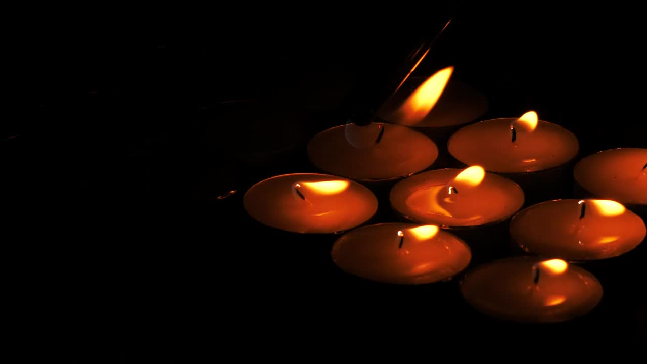 Download Stock Video Lighting Candles In The Dark Animated Wallpaper