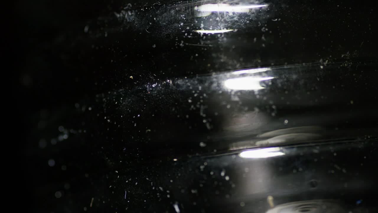 Download Stock Video Light Reflection On Black Surface Animated Wallpaper