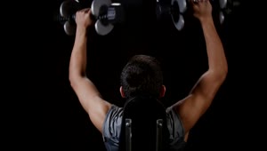 Stock Video Lifting Weights Against A Dark Background Animated Wallpaper