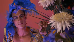 Stock Video Lgbtq Boy With Extravagant Clothes With Feathers And Flowers Animated Wallpaper
