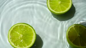 Stock Video Lemons Falling Into A Pond With Water Animated Wallpaper