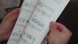 Stock Video Leafing Through A Notebook With Sheet Music Animated Wallpaper
