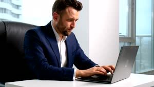 Stock Video Lawyer Types On Laptop In Highrise Office With City View Animated Wallpaper