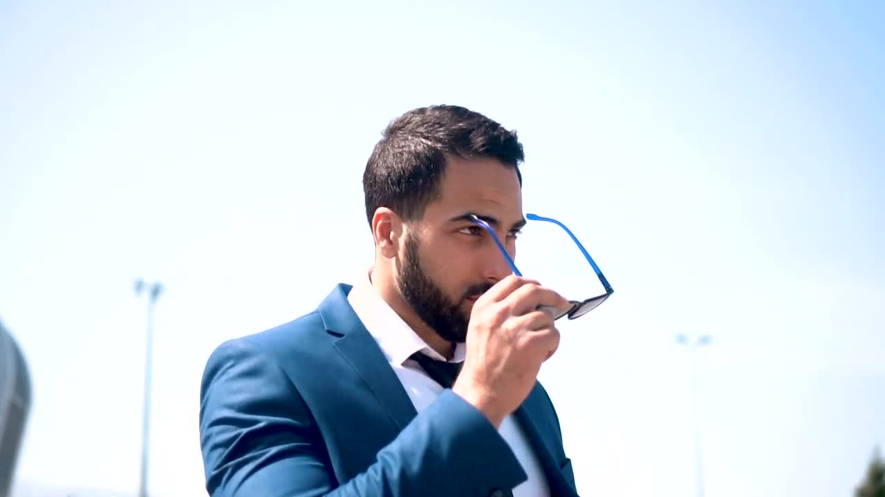 Download Stock Video Lawyer Puts On Sunglasses In Front Of Modern Building Animated Wallpaper