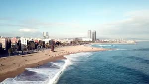Stock Video Large Waves Breaking Along A City Beach Smal Animated Wallpaper