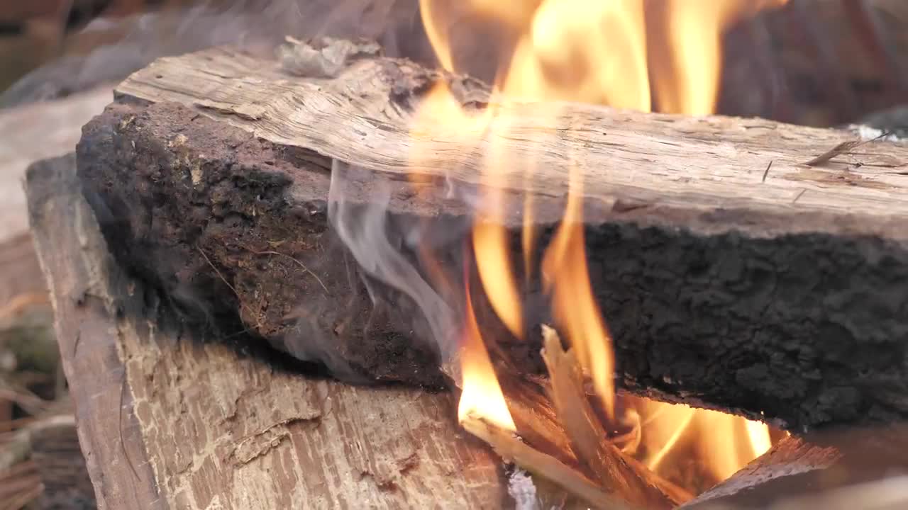 Download Stock Video Large Piece Of Wood On Flames Animated Wallpaper