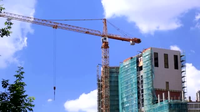 Download Stock Video Large Crane Over A Construction Site Smal Animated Wallpaper