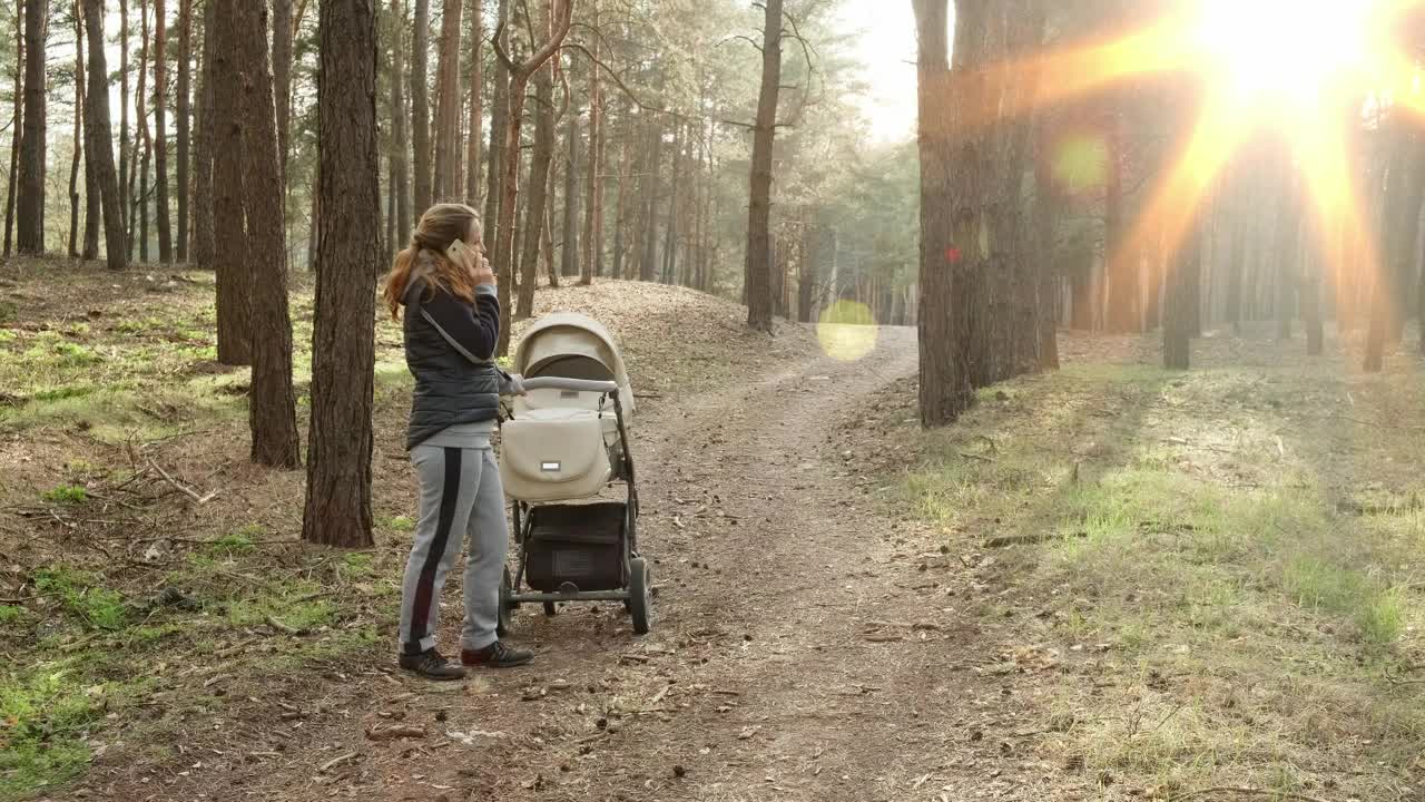 Download Stock Video Mother Talking On The Phone At Wood Animated Wallpaper