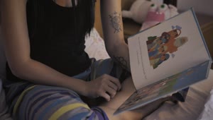 Stock Video Mother Reading A Book To Her Little Daughter Before Be Animated Wallpaper