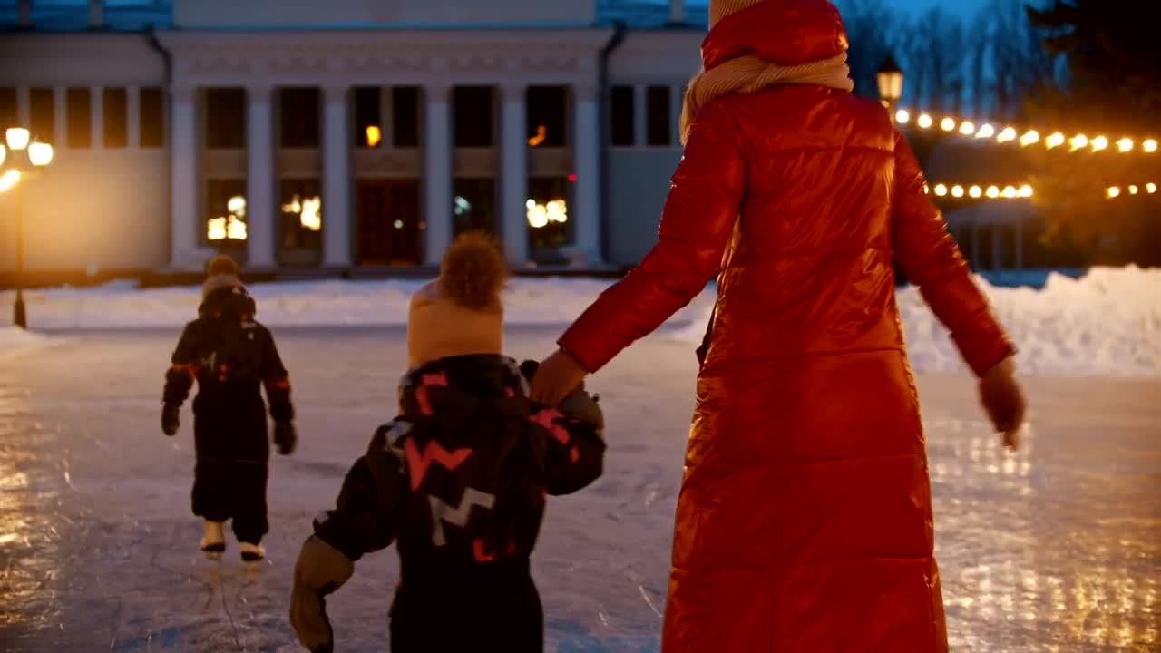 Download Stock Video Mother Doing Ice Skating With Her Small Childre Animated Wallpaper