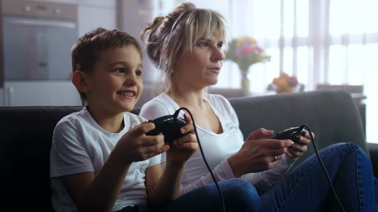 Download Stock Video Mother And Son Playing An Old Consol Animated Wallpaper