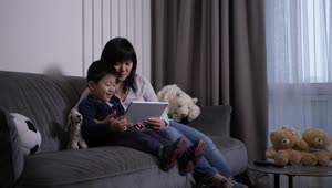 Stock Video Mother And Her Son Viewing A Table Animated Wallpaper