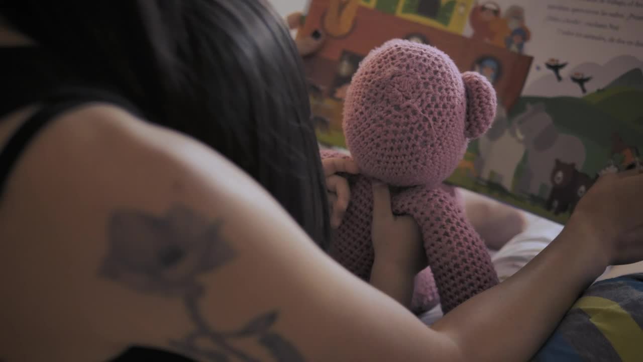 Download Stock Video Mother And Daughter Reading A Childrens Book Back Vie Animated Wallpaper