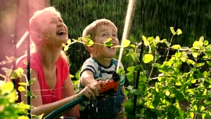 Stock Video Mother And Child Spraying A Hos Animated Wallpaper