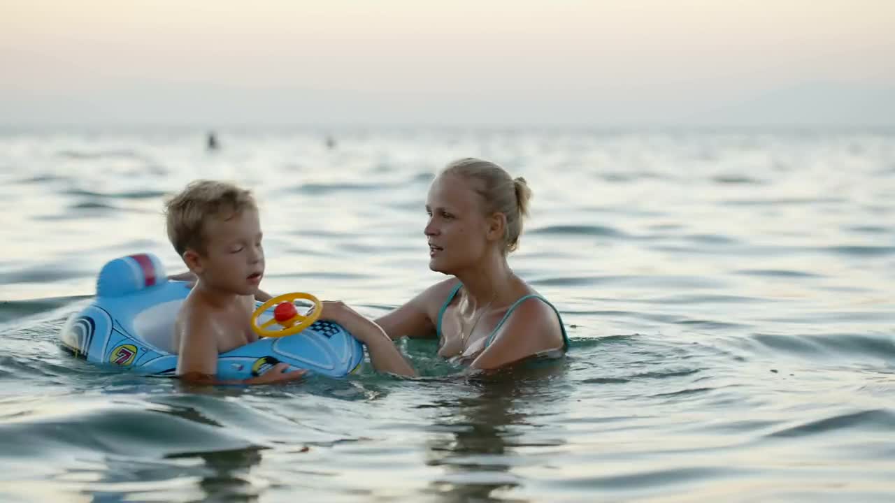 Download Stock Video Mother And Child Playing In The Ocea Animated Wallpaper