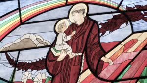 Stock Video Monk Carrying A Child Depicted In The Stained Glass Windo Animated Wallpaper