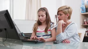 Stock Video Mom Helps Daughter With Distance Learning On P Animated Wallpaper