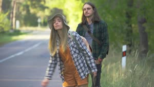 Stock Video Millennial Couple Hitchhiking On Forest Roa Animated Wallpaper