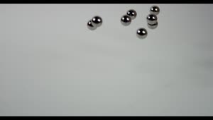 Stock Video Metal Pellets Fall On White Surfac Animated Wallpaper
