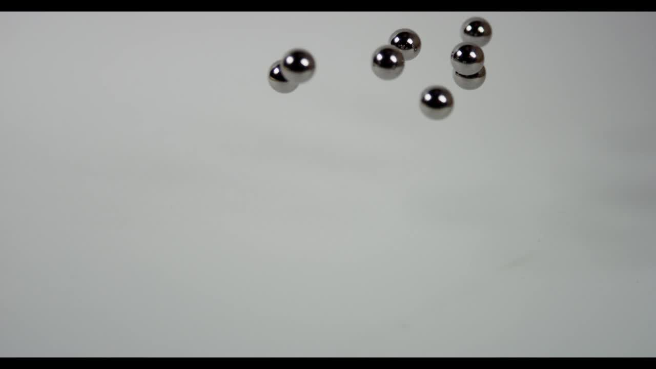 Download Stock Video Metal Pellets Fall On White Surfac Animated Wallpaper