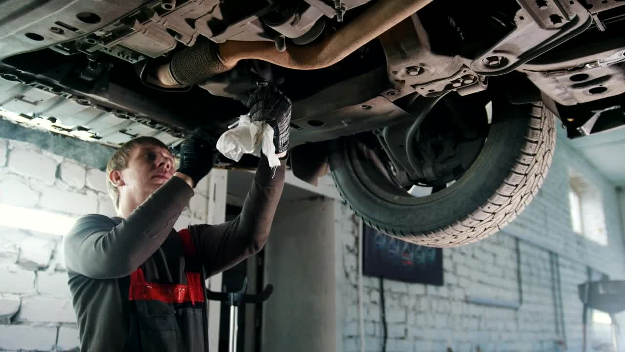 Download Stock Video Mechanic Working In The Bottom Of A Ca Animated Wallpaper