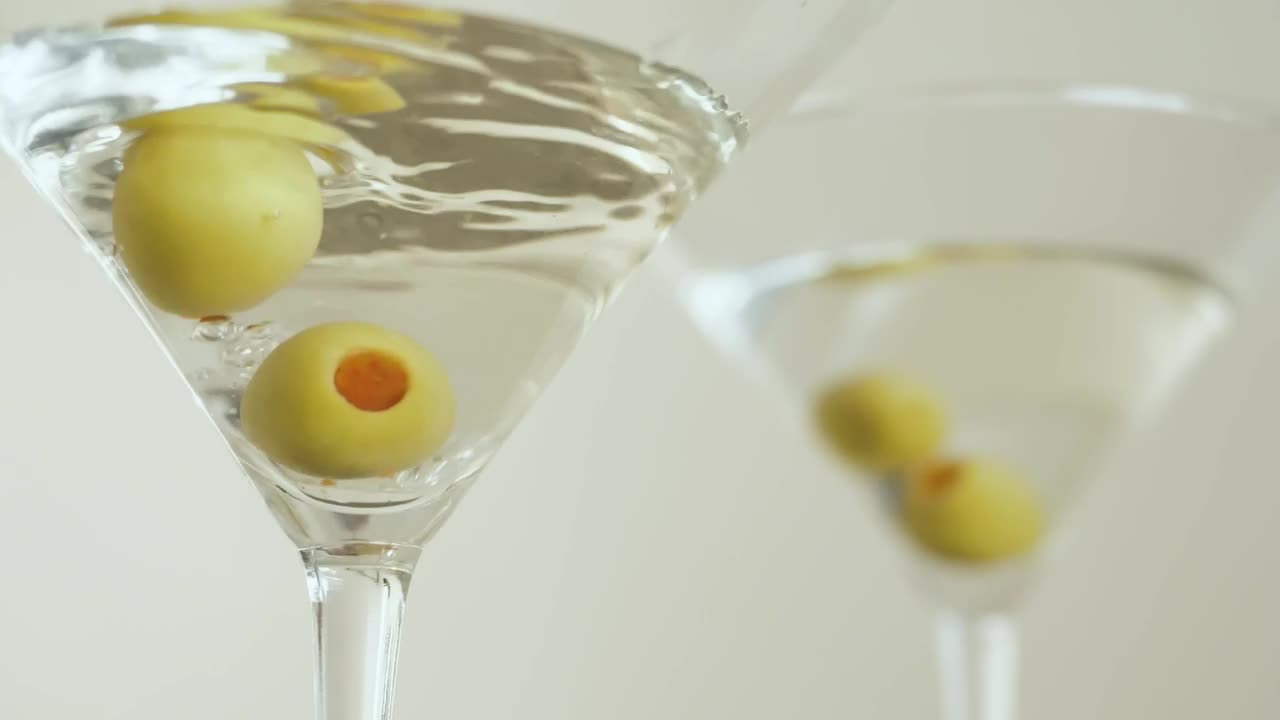 Download Stock Video Martini Glasses With Olives On A White Backgroun Animated Wallpaper