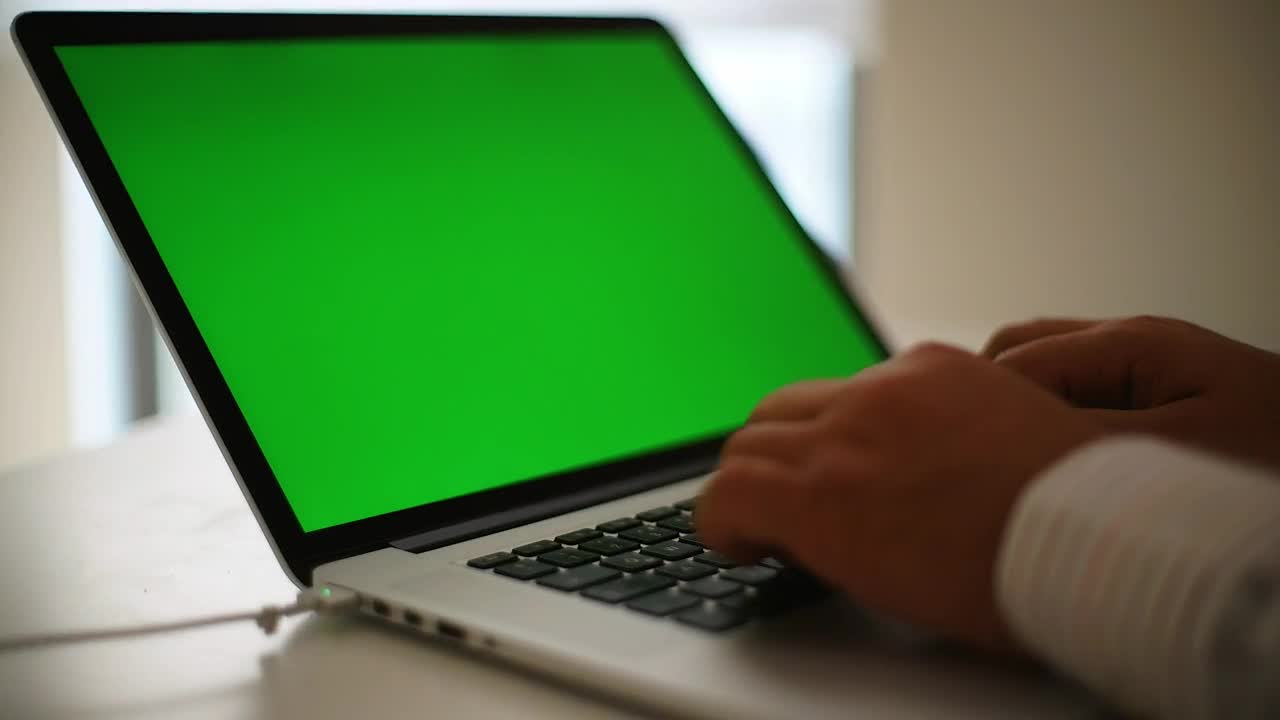 Download Stock Video Man Working On A Laptop With A Green Scree Animated Wallpaper