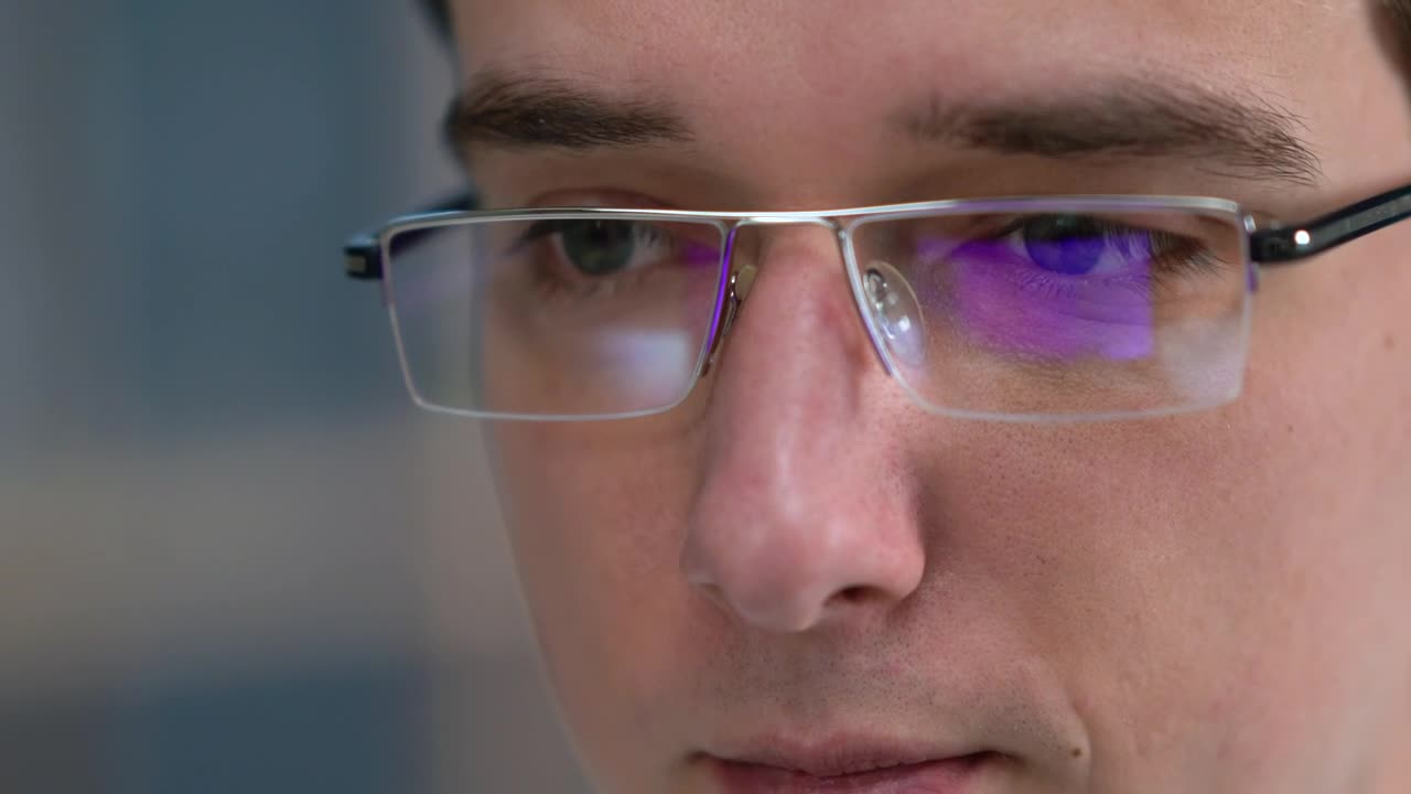 Download Stock Video Man With Glasses Looking At Monito Animated Wallpaper